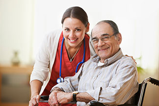 helpful assisted living nurse with elderly man at The Delaney at South Shore - small size