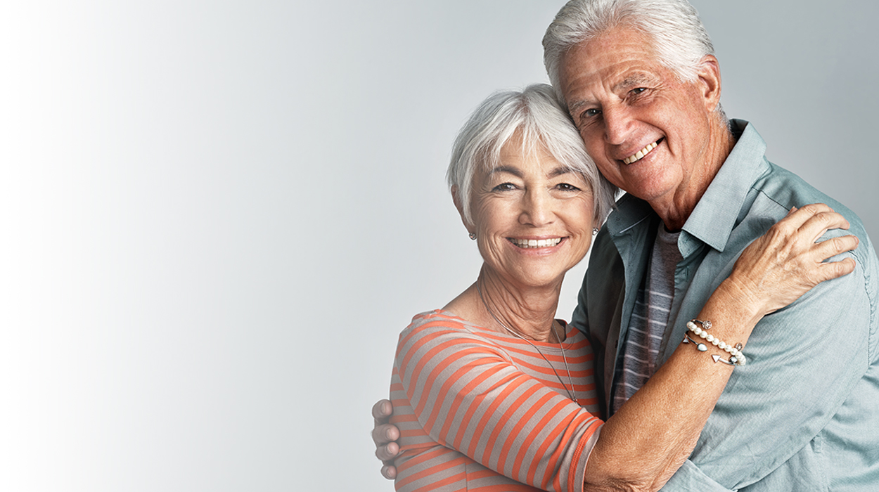 white fade with elderly couple hugging at The Delaney at South Shore senior living