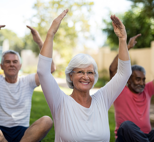 Woman doing seated stretches during outdoor exercise class